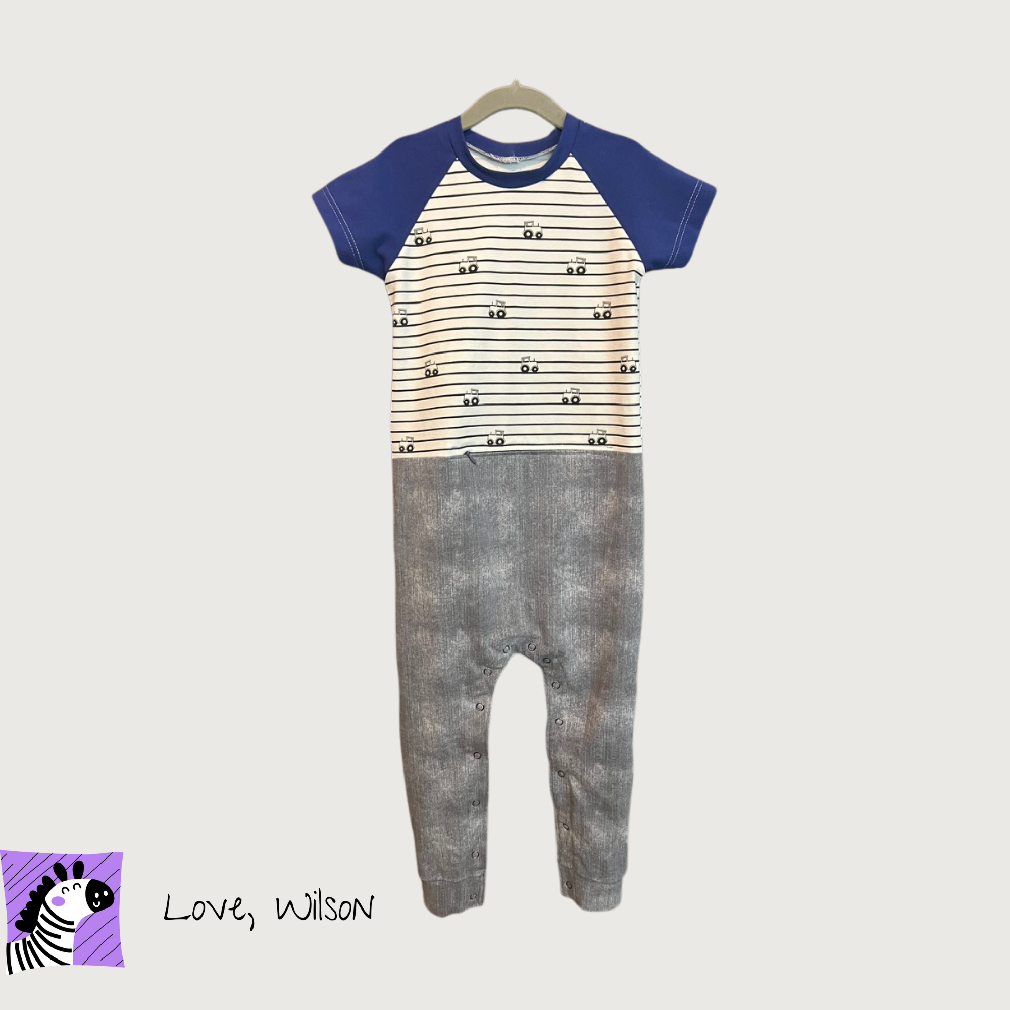 Children's adaptive g-tube romper, faux denim pants with striped design top, zipper to access feeding tube or port, and snaps on the pant legs